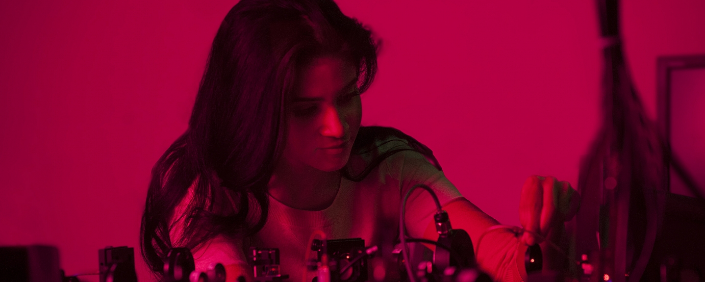 Red tinted photo of girl in lab