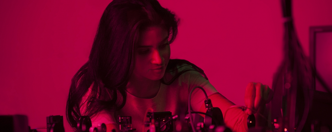 Red tinted photo of girl in lab