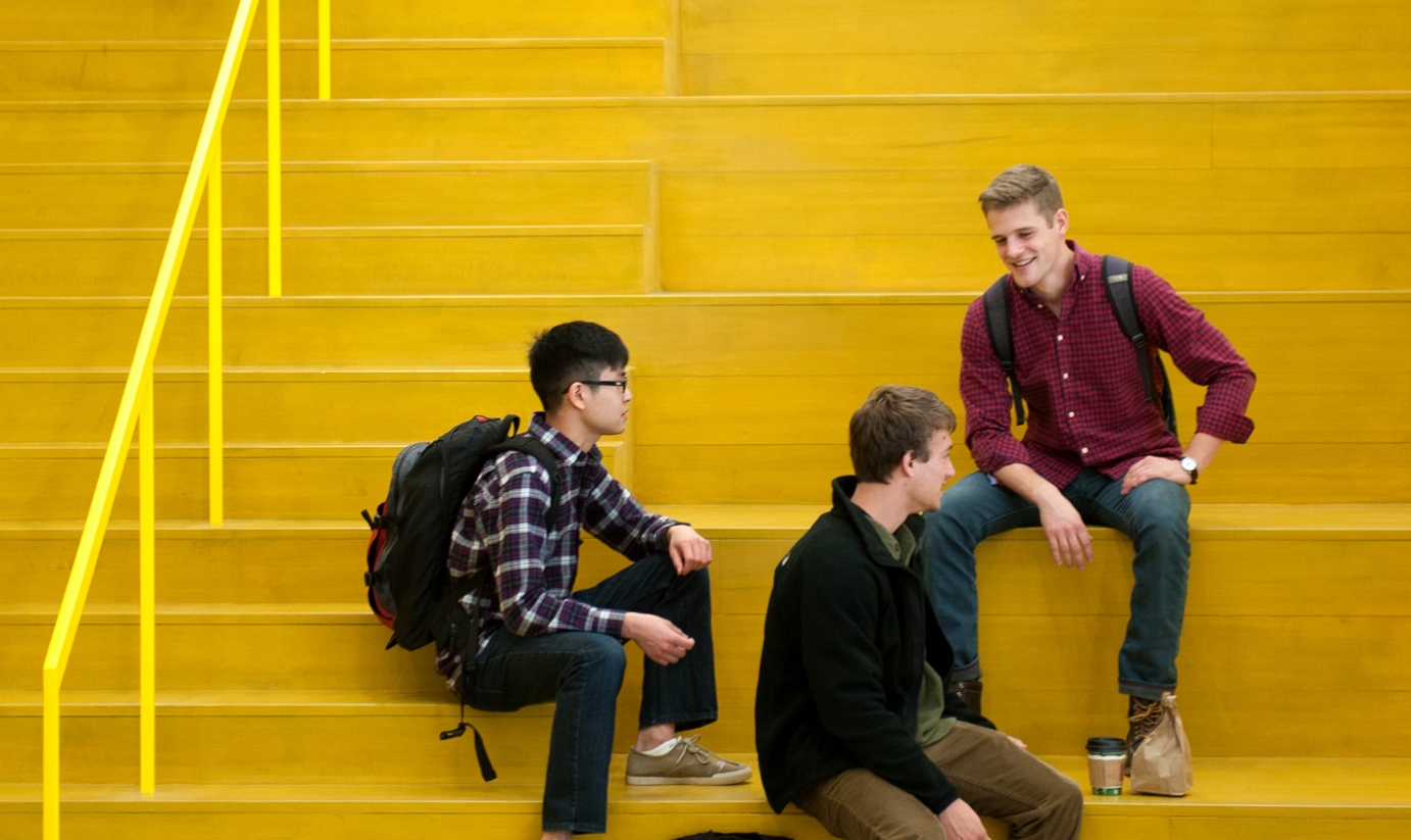 Three students on yellow steps of Hunt Library