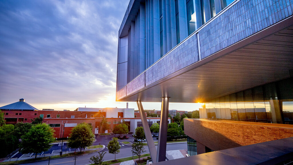 The exterior of Fitts-Woolard Hall at sunset.