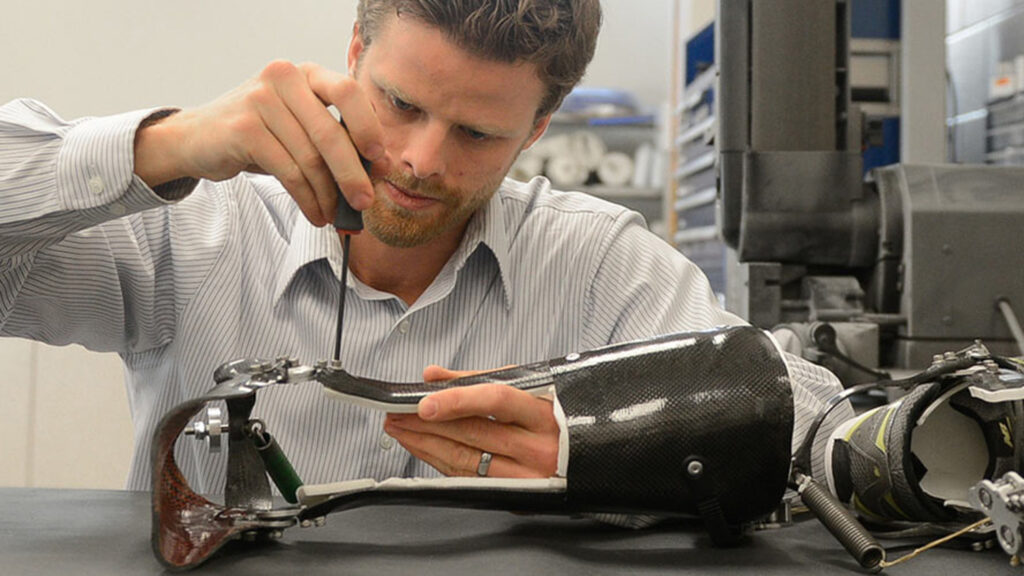 A tightly cropped photo of a man working in a lab.