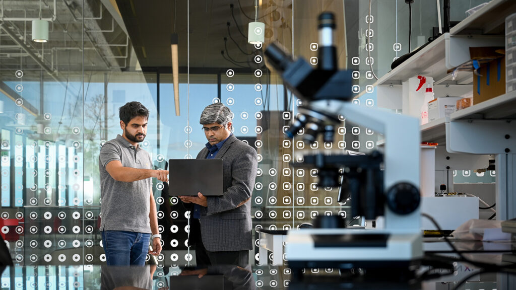 Two researchers work in a dynamic lab space.