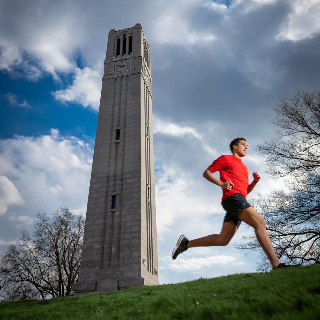 A runner strides by the Memorial Belltower.
