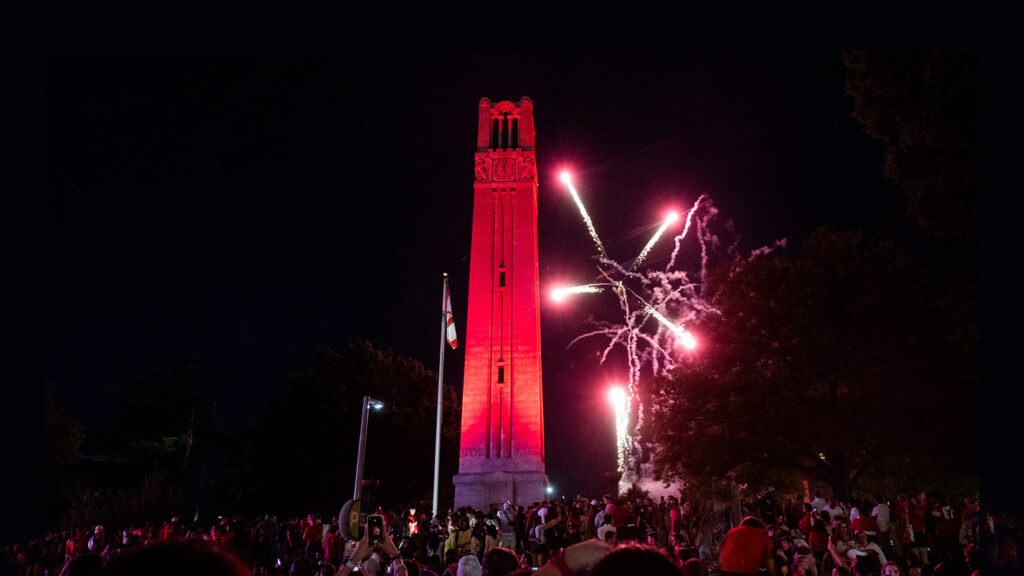 A photo of fireworks at the Belltower, where the crowd at the bottom has been slightly expanded with generative fill.