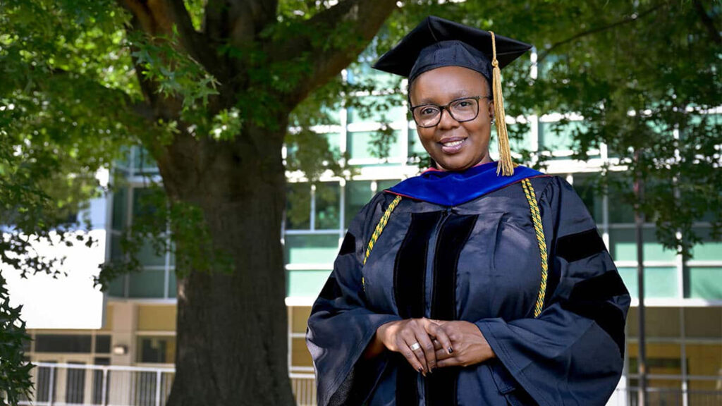 A Ph.D. student in her graduation robes.