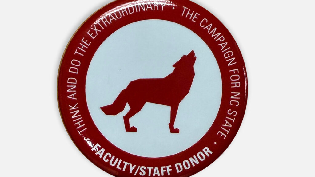 A circle wolf at the center of a pin.