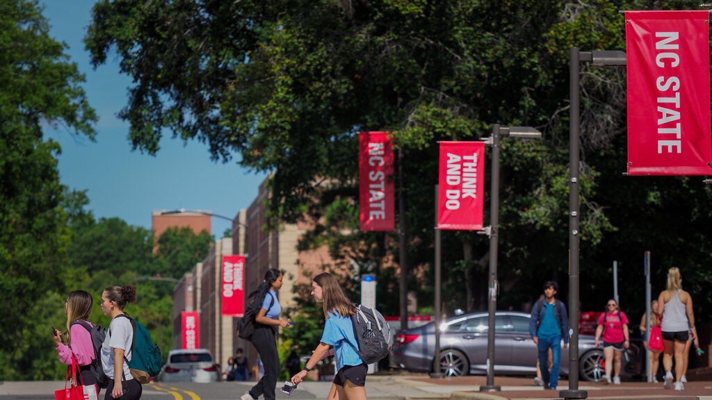 Hillsborough Street lined with "NC State" and "Think and Do" banners.