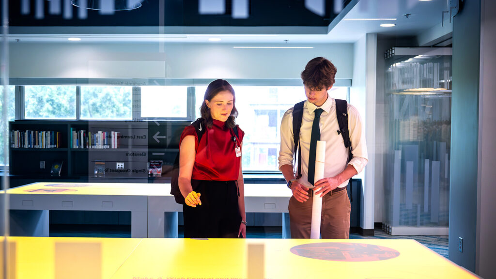 Two students explore a data visualization lab in Hunt Library.